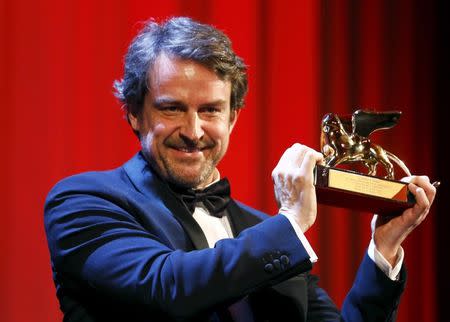 Director Lorenzo Vigas holds the Golden Lion prize for his movie "Desde Alla" (From Afar) during the award ceremony at the 72nd Venice Film Festival, northern Italy September 12, 2015. REUTERS/Stefano Rellandini