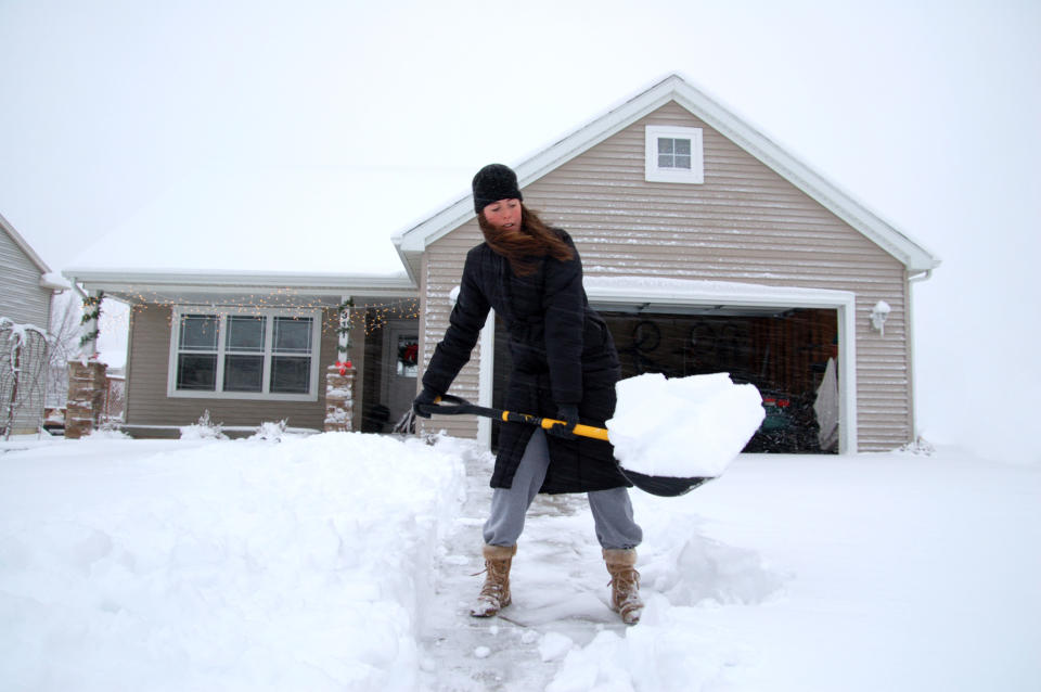 Woman using snow shovel from Canadian Tire during large winter storm