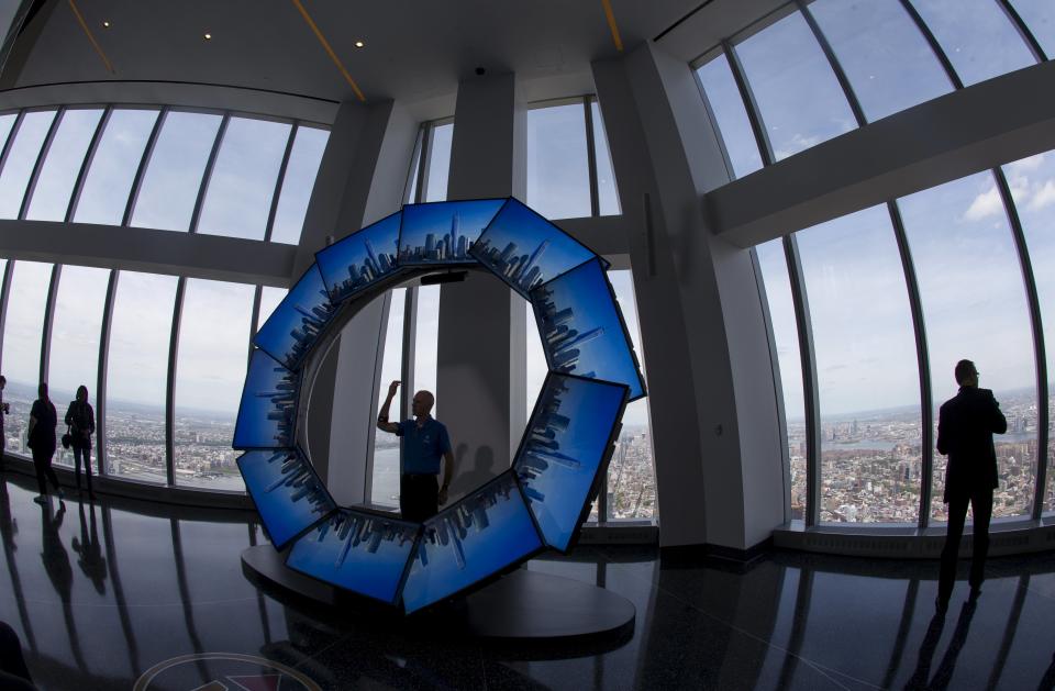 A worker stands inside the "City Pulse" interactive display in the One World Observatory observation deck on the 100th floor of the One World Trade center tower in New York