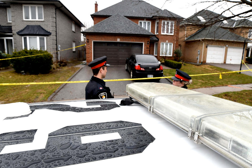 Police officers wait for a search warrant in front of the home of Alek Minassian, in Richmond Hill, Ontario, Canada, April 25, 2018.   REUTERS/Saul Porto