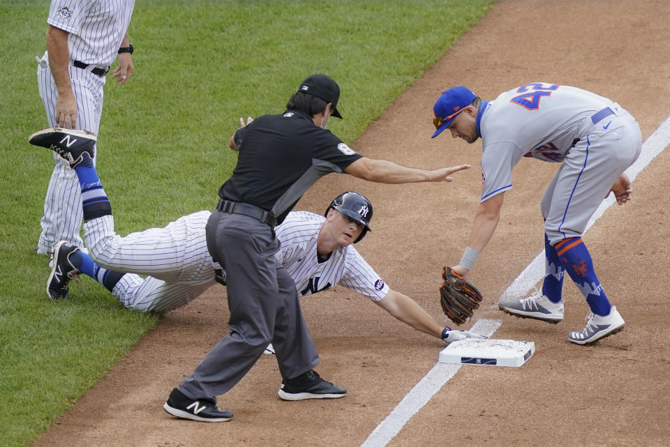 New York Yankees' DJ LeMahieu, center, beats the tag at third by New York Mets third baseman J.D. Davis, right, on a triple hit off starting pitcher Robert Gsellman in the third inning of a baseball game, Saturday, Aug. 29, 2020, in New York. (AP Photo/John Minchillo)