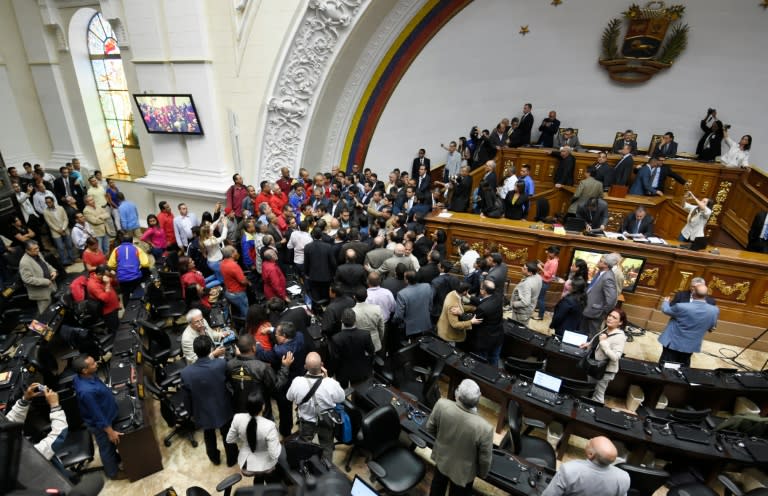 Opposition deputies argue with government representatives during a National Assembly special session to vote to open a political trial against President Nicolas Maduro, in Caracas