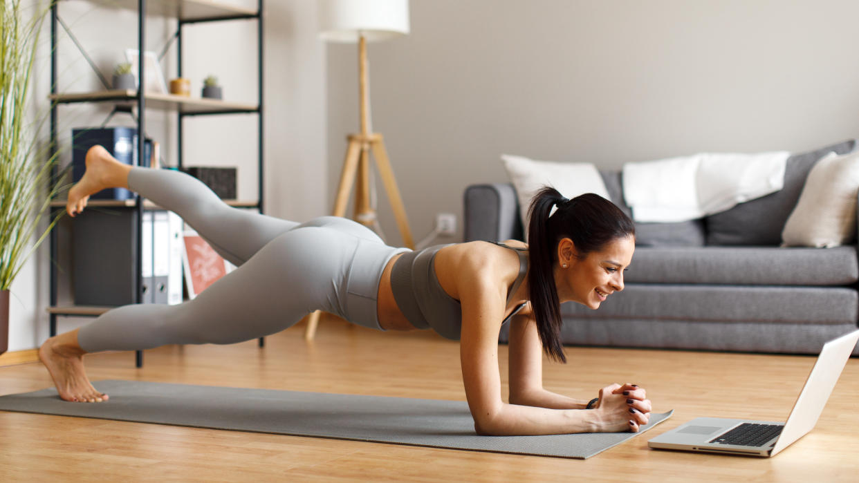  Woman doing a core workout at home. 