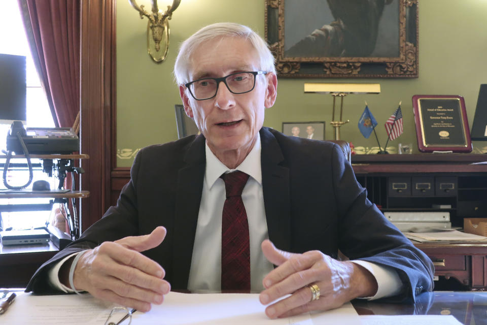 FILE - In this Dec. 4, 2019 file photo, Wisconsin Gov. Tony Evers speaks during an interview with The Associated Press in his Statehouse office in Madison, Wis. Republican-controlled legislatures are increasingly trying to strip Democratic governors of their executive authority to close businesses and schools, a power grab that channels frustration over the economic toll of the coronavirus pandemic but could come with long-term consequences for how their states fight disease. (AP Photo/Scott Bauer, File)