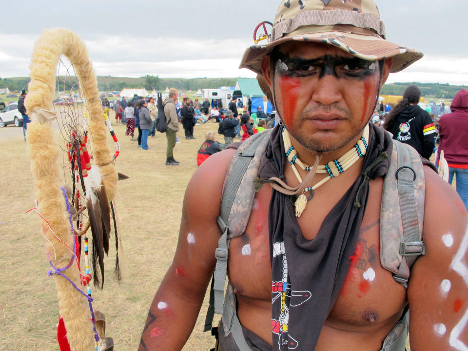 <p>Jon Don Ilone Reed, a member of South Dakota’s Cheyenne River Sioux tribe, joins an oil pipeline protest near the Standing Rock Sioux reservation in North Dakota, on Aug. 25, 2016. Reed said he fought in Iraq and is now “fighting for our children and our water.” (Photo: James MacPherson/AP) </p>