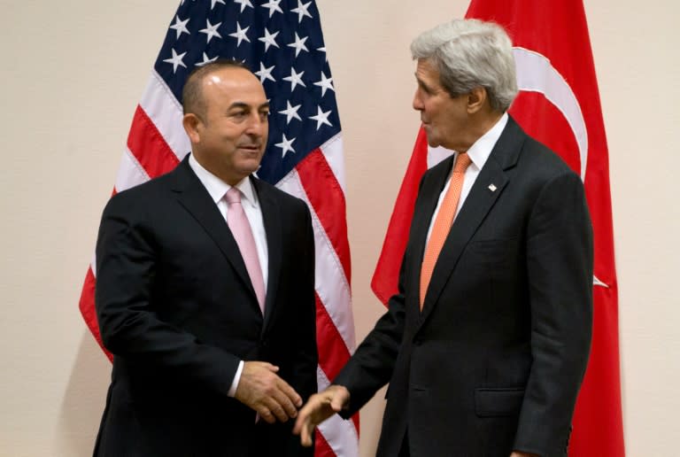 Turkish Foreign Minister Mevlut Cavusoglu (L) speaks with US Secretary of State John Kerry during a meeting of the North Atlantic Council at NATO headquarters in Brussels on May 20, 2016