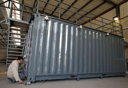 A worker transforms an old steel shipping container which may later be used as living spaces or shops or restaurants in Cairo, Egypt April 19, 2017. Picture taken April 19, 2017. REUTERS/Mohamed Abd El Ghany