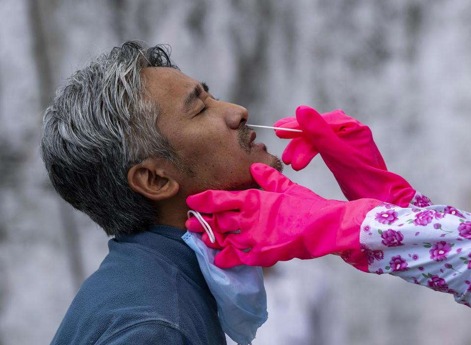 A doctor takes a nasal swab to be tested for the coronavirus in Dharmsala, India, Saturday, May 9, 2020. India relaxed some coronavirus lockdown restrictions on Monday even as the pace of infection picked up and reopenings drew crowds of people. (AP Photo/Ashwini Bhatia)