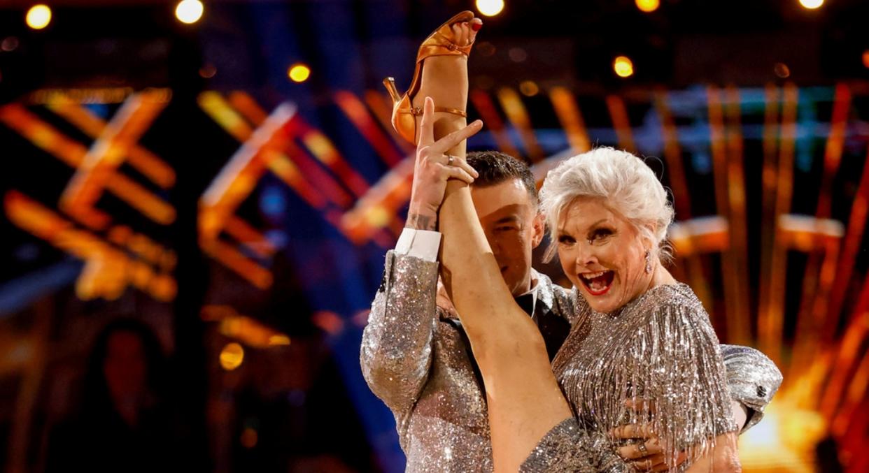 Angela Rippon and her professional dancing partner Kai Widdrington pose with Rippon's leg raised high above her head during her first dance in Strictly Come Dancing