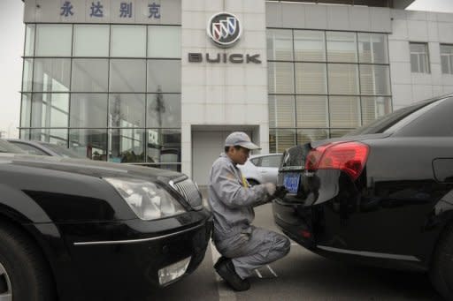 A mechanic works on a Buick at a General Motors dealership in Shanghai. Foreign carmakers in China say Beijing is pressuring them to produce dedicated new brands so their local partners can gain technical know-how, but experts warn the strategy could backfire