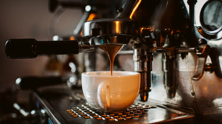 espresso brewing into mug