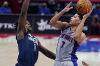 Detroit Pistons guard Killian Hayes (7) shoots over the defense of Minnesota Timberwolves forward Anthony Edwards (1) during the second half of an NBA basketball game, Tuesday, May 11, 2021, in Detroit. (AP Photo/Carlos Osorio)