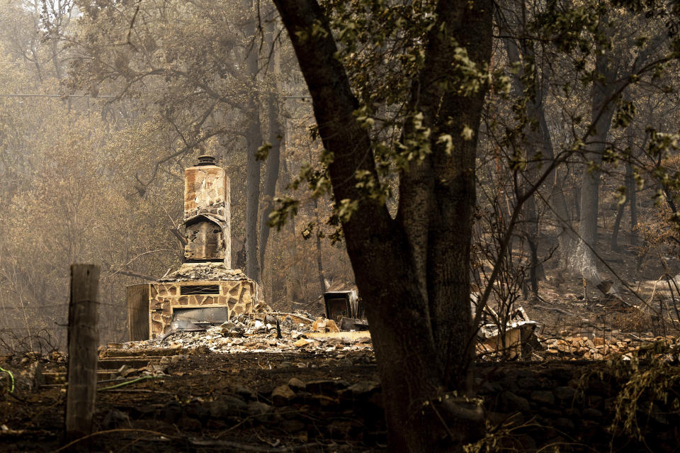 A chimney stands at a home destroyed by the McKinney Fire on Tuesday, Aug. 2, 2022, in Klamath National Forest, Calif. (AP Photo/Noah Berger)