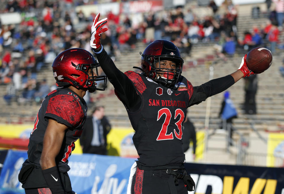 San Diego State cornerback Darren Hall (23) celebrates with teammate Luq Barcoo after scoring a touchdown on a Central Michigan fumble return during the second half of the New Mexico Bowl NCAA college football game on Saturday, Dec. 21, 2019 in Albuquerque, N.M. (AP Photo/Andres Leighton)