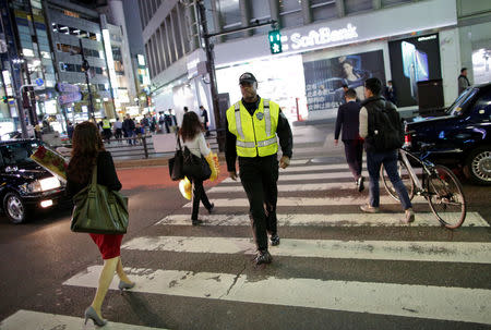 Japanese security firm Executive Protection Inc. employee 59-year-old Antonio Nathaniel King of the U.S. patrols on the street at Roppongi shopping and amusement district in Tokyo, Japan November 1, 2018. Picture taken November 1, 2018. REUTERS/Issei Kato