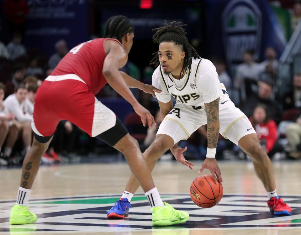 Akron Zips guard Greg Tribble (2) stares down Miami (OH) Redhawks guard Darweshi Hunter (4) during the second half of an NCAA college basketball game in the quarterfinals of the Mid-American Conference Tournament at Rocket Mortgage FieldHouse, Thursday, March 14, 2024, in Cleveland, Ohio.