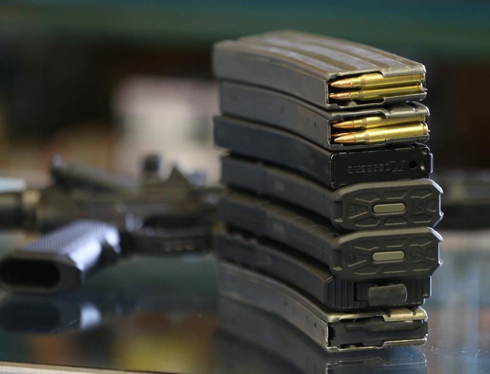 Two 30-round clips filled with .223 cartridges, and other high-capacity clips for an AR-15, are shown at a gun store in Orem, Utah.