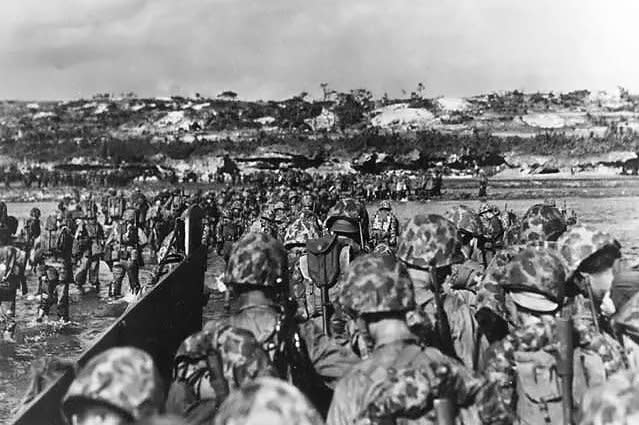 U.S. Marine reinforcements wade ashore to support the beachhead on Okinawa, Japan, on April 1, 1945. File Photo courtesy of the U.S. Department of Defense