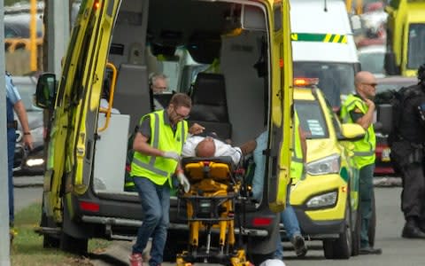 An injured person is loaded into an ambulance at the Al Noor mosque in Christchurch - Credit: Reuters