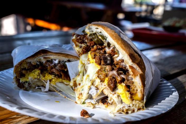 Pupusería La Chicana’s torta Cubana with its adobada, carne asada, ham, cheese, fried egg, beans and pickled jalapeños, sits ready to eat on Wednesday, Nov. 16, 2022 in Woodland.