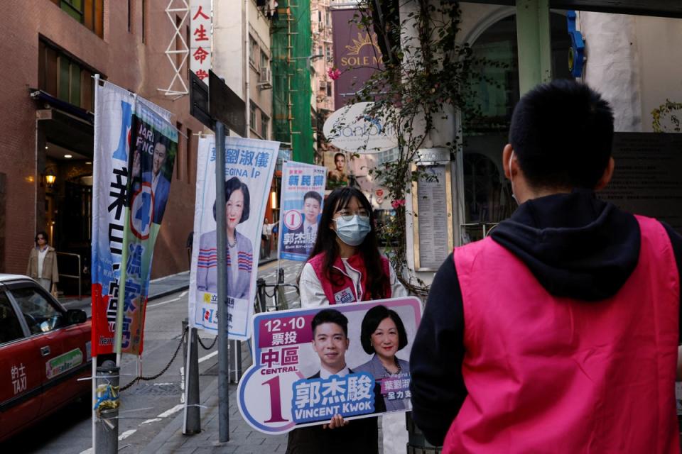 A volunteer campaigns for the New People’s Party during the District Council election in Hong Kong (Reuters)