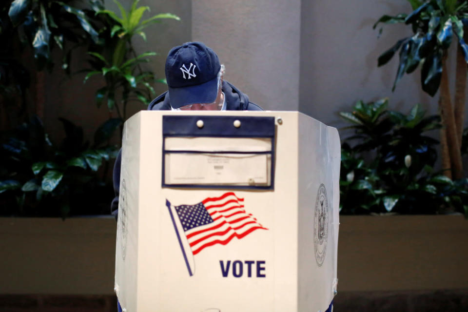 A man fills out a ballot