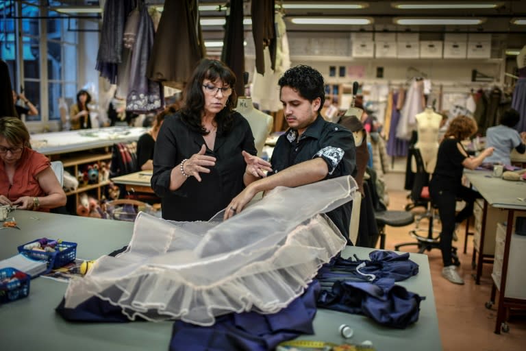 Tutor and workshop head Anne-Marie Legrand, left, promises Tulio Morais that he will soon put together his first tutu for "Swan Lake" in January