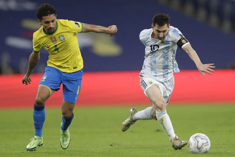 Argentina's Lionel Messi, right, and Brazil's Marquinhos battle for the ball during the Copa America final soccer match at the Maracana stadium in Rio de Janeiro, Brazil, Saturday, July 10, 2021. (AP Photo/Andre Penner)