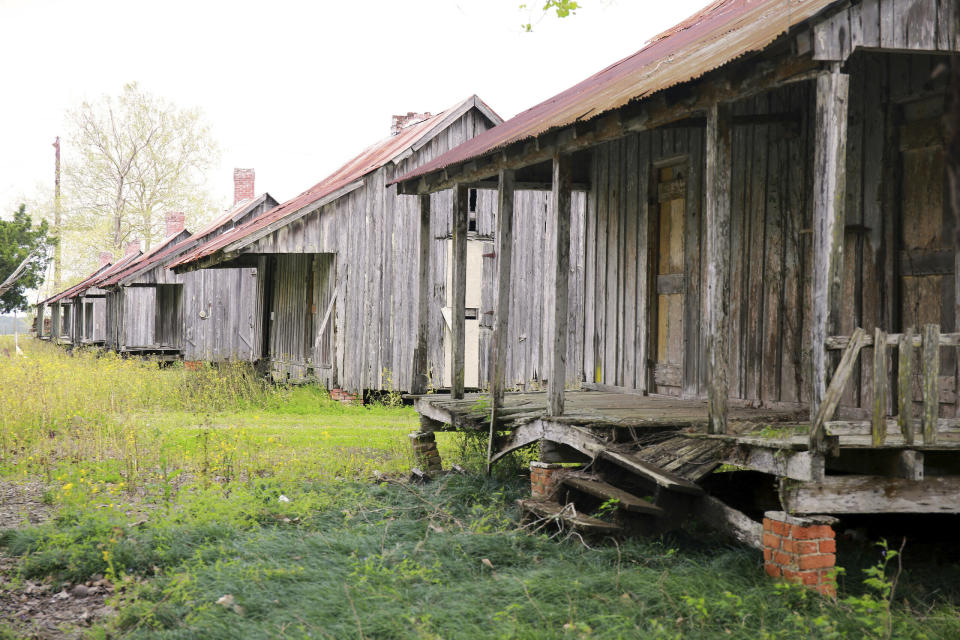 This March 13, 2019 photo shows old sharecroppers cabins in Raceland, La. A new website that traces the family histories of hundreds of black slaves sold by Georgetown University and the Maryland Jesuits to southern Louisiana in 1838 has launched as the nation observes Juneteenth, the annual observance of the 1865 announcement of the abolition of slavery in America. The GU272 Memory Project website made public, Wednesday, June 19, 2019, includes documents, photographs and the indexed genealogies of thousands of descendants of the slaves, as well as recorded interviews with dozens of their living descendants. (Claire Vail/American Ancestors/New England Historic Genealogical Society via AP)