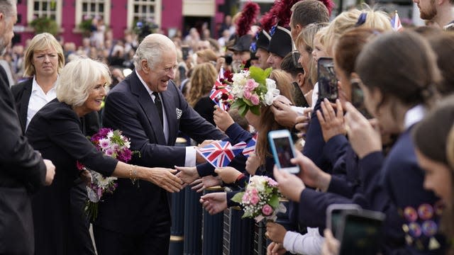 Charles and Camilla speak to people in the crowd 