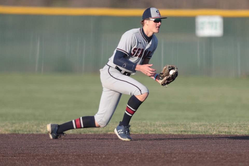 Seaman junior Bryer Finley (1) scoops up a Shawnee Heights hit in the sixth inning of Wednesday's game.