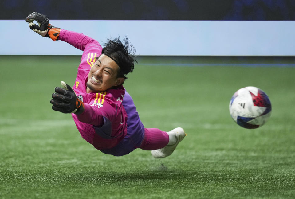 Los Angeles Galaxy's Gaston Brugman scores past a diving Vancouver Whitecaps goalkeeper Yohei Takaoka during the second half of an MLS soccer match Saturday, July 15, 2023, in Vancouver, British Columbia. (Darryl Dyck/The Canadian Press via AP)