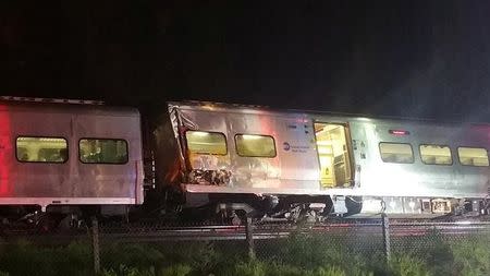 A train sits derailed near the community of New Hyde Park on Long Island in New York, U.S., October 8, 2016. Sarah Qamar/Handout via REUTERS