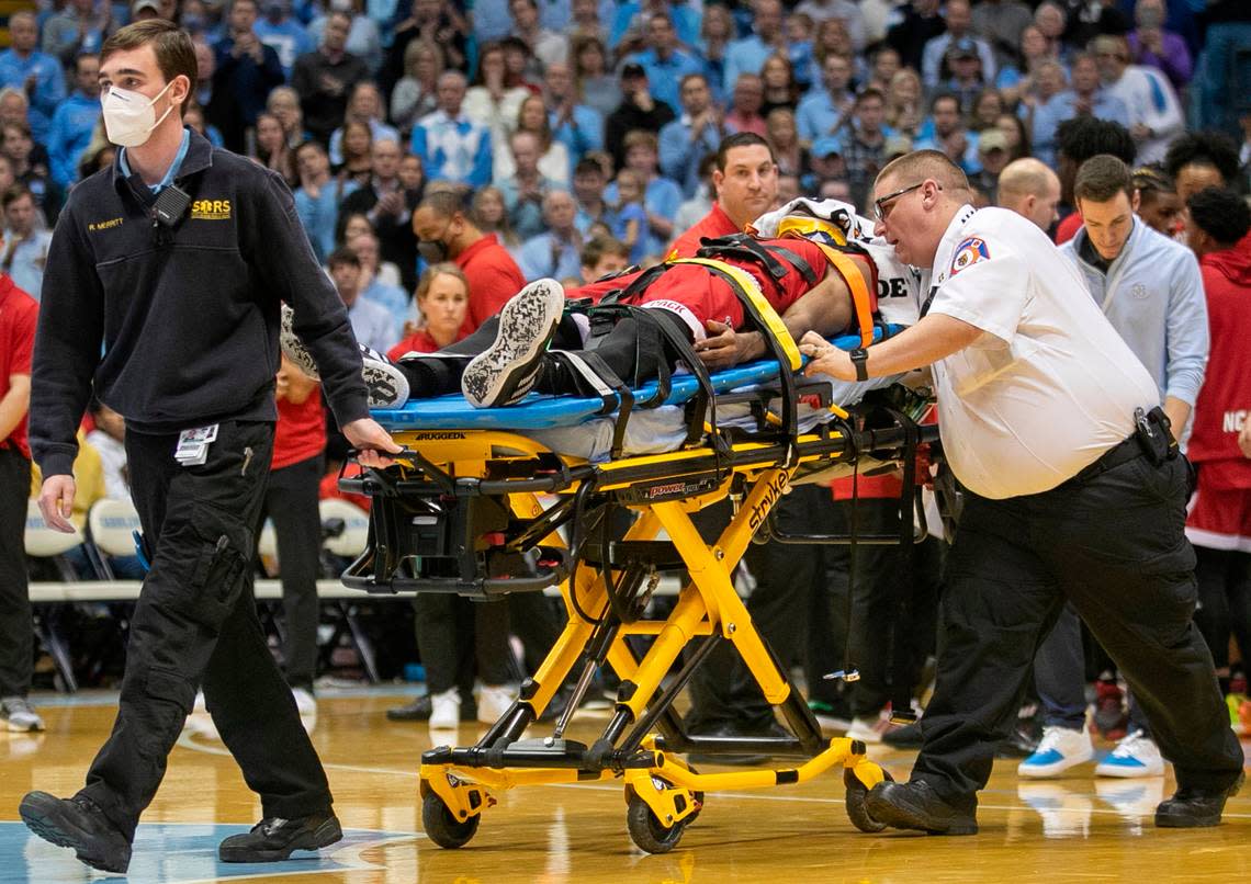 N.C. State’s Terquavion Smith (0) is taken off the court on a stretcher after falling on a hard foul by North Carolina’s Leaky Black in the second half. Black was ejected from the game on Saturday, January 21, 2023 at the Smith Center in Chapel Hill, N.C.