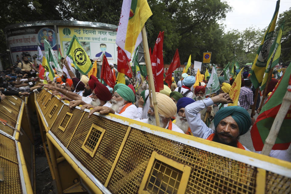 Farmers shout anti government slogans during a protest in New Delhi, India, Thursday, July 22, 2021. More than 200 farmers on Thursday began a protest near India's Parliament to mark eight months of their agitation against new agricultural laws that they say will devastate their income. (AP Photo/Manish Swarup)