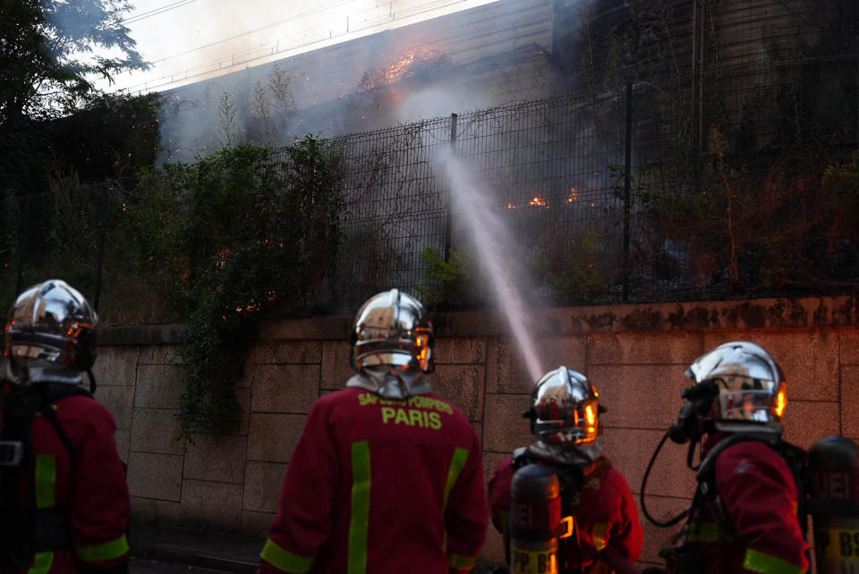 Firefighters work to put out a fire on the sidelines of a demonstration in Nanterre, on June 27, 2023.<span class="copyright">Zakaria Abdelkafi—AFP/Getty Images</span>