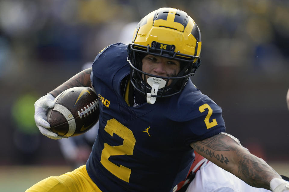 FILE - Michigan running back Blake Corum (2) runs the ball against Illinois in the first half of an NCAA college football game in Ann Arbor, Mich., Saturday, Nov. 19, 2022. Corum was selected to The Associated Press All-America team released Monday, Dec. 12, 2022.(AP Photo/Paul Sancya, File)