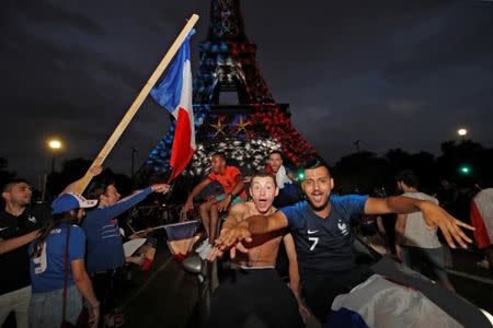 Soccer Football - World Cup - Final - France vs Croatia - Paris, France, July 15, 2018 - Blue, White, and Red lights and two World Cup stars are projected on the Eiffel Tower after France win the Soccer World Cup final. REUTERS/Philippe Wojazer