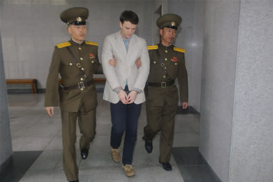 American student Otto Frederick Warmbier, center, arrives at a court for his trial in Pyongyang on March 16, 2016.