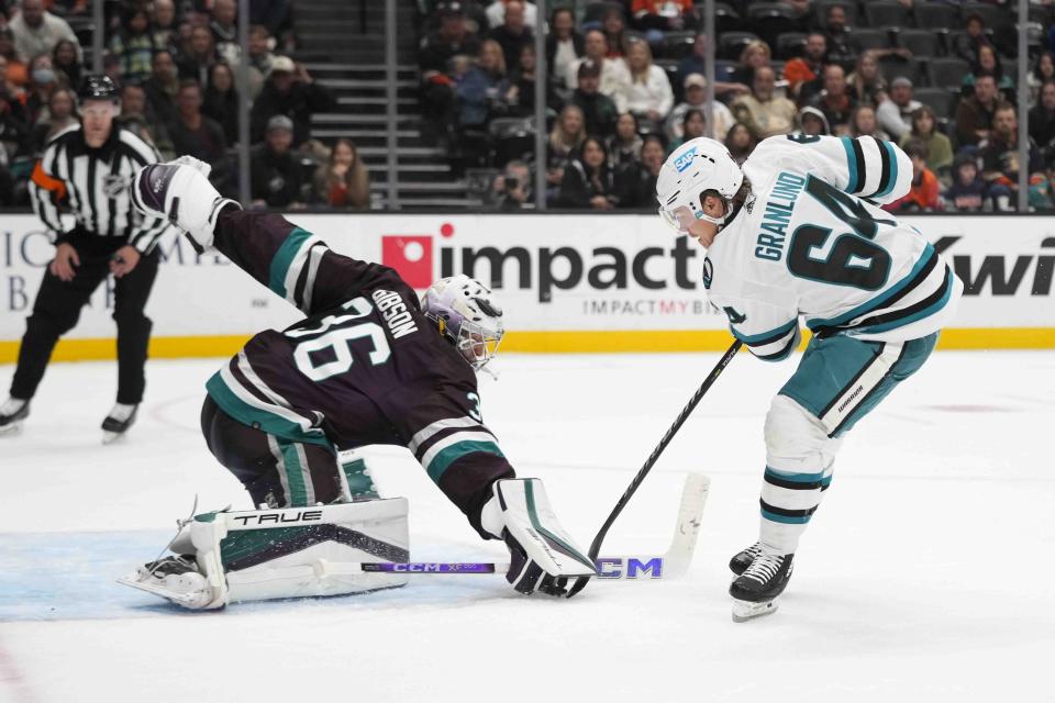 Anaheim Ducks goaltender John Gibson (36) stops a shot by San Jose Sharks' Mitchell Russell (64) during the second period of an NHL hockey game Sunday, Nov. 12, 2023, in Anaheim, Calif. (AP Photo/Jae C. Hong)