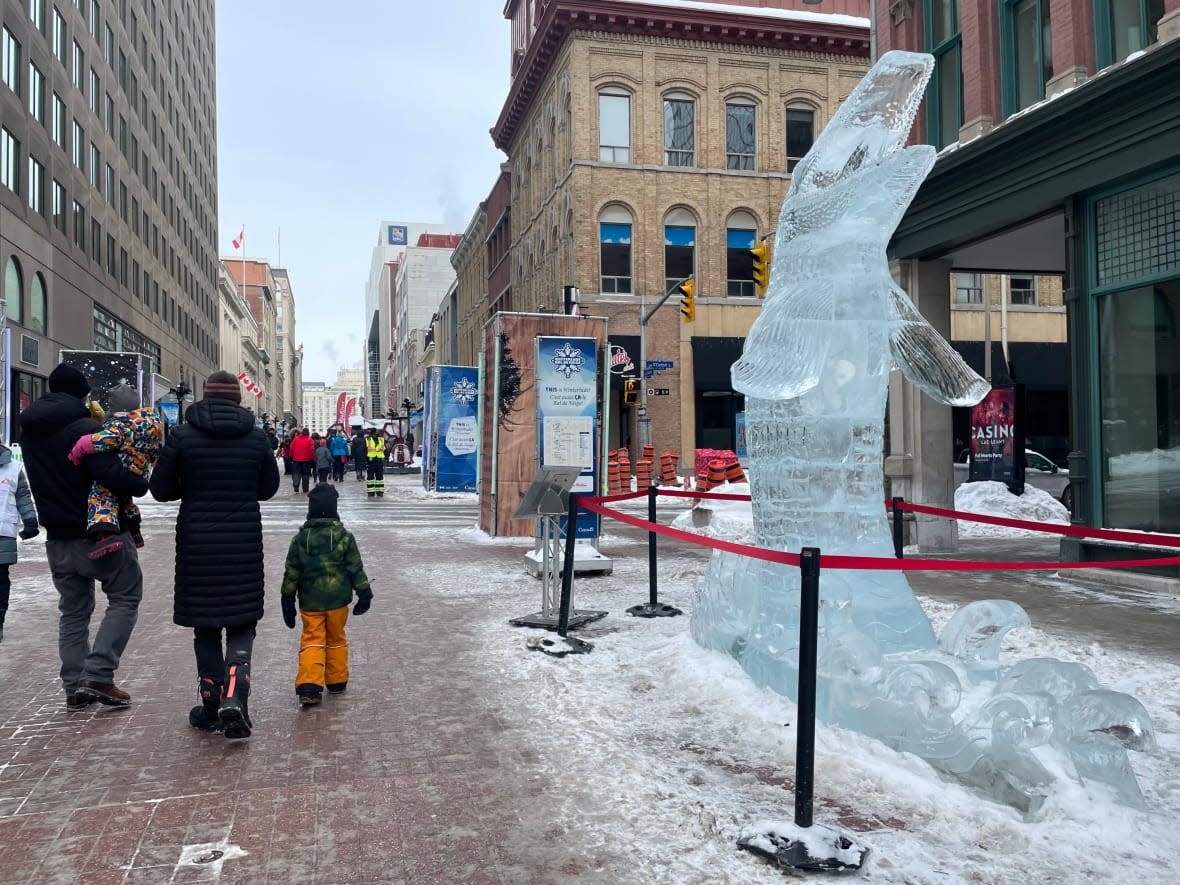 Dozens of people gathered on Sparks Street Saturday to soak up Winterlude's first in-person festivities since the start of the COVID-19 pandemic.  (Avanthika Anand/CBC - image credit)