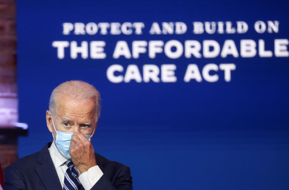 U.S. President-elect Joe Biden adjusts his face mask after during a brief news conference, where he discussed health care and the Affordable Care Act (Obamacare, at the theater serving as his transition headquarters in Wilmington, Delaware, U.S., November 10, 2020. REUTERS/Jonathan Ernst??