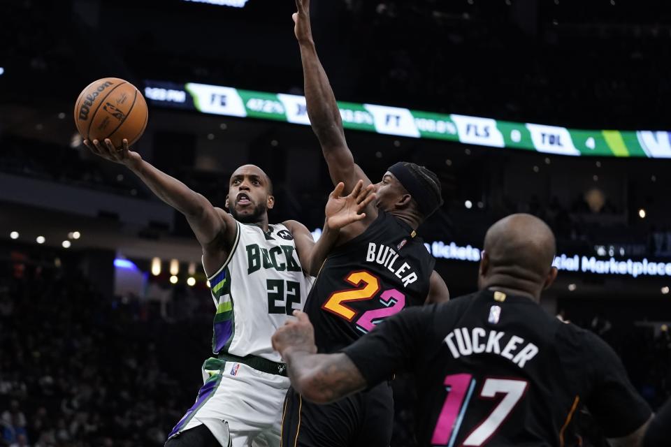 Milwaukee Bucks' Khris Middleton shoots past Miami Heat's Jimmy Butler during the second half of an NBA basketball game Wednesday, March 2, 2022, in Milwaukee. The Bucks won 120-119. (AP Photo/Morry Gash)