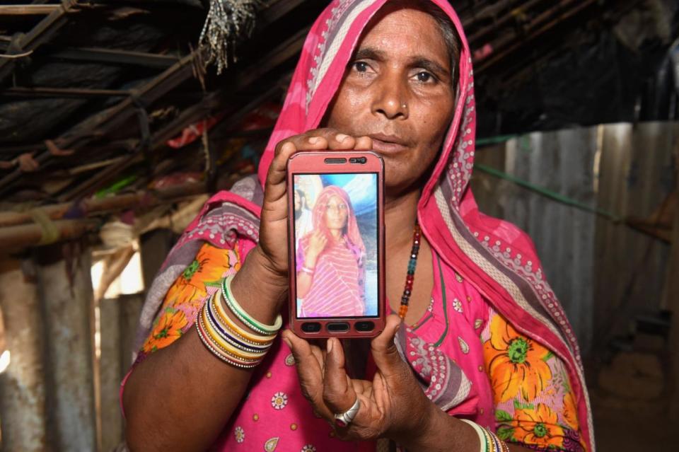 Mohinidevi Nath shows a phone photo of her cousin Shantadevi Nath, who was killed by a mob that falsely believed she was intent on abducting children in Ahmedabad (Sam Panthaky/AFP/Getty Images)