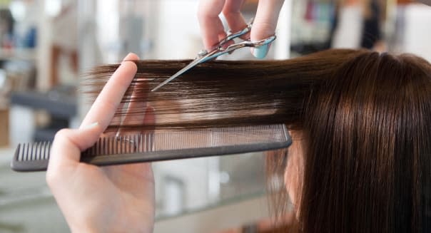 hairdresser cutting client's...