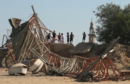 Palestinians look at damage at a training camp belonging to the Islamist group Hamas after it was hit by an Israeli air strike in the northern Gaza Strip September 19, 2015. REUTERS/Mohammed Salem