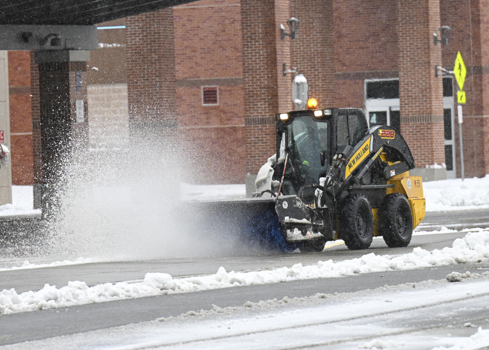 Crews remove snow from the Albany International Airport during a winter snow storm Tuesday, March 14, 2023, in Albany, N.Y. (AP Photo/Hans Pennink)