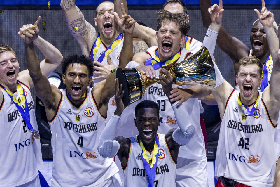 Germany, with Dennis Schröder holding the trophy, celebrates after winning the FIBA Basketball World Cup championship over Serbia at Mall of Asia Arena in Manila, Philippines, on Sept. 10, 2023. (Photo by Ezra Acayan/Getty Images)