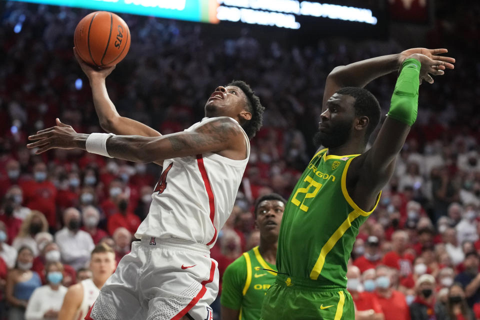 Arizona guard Dalen Terry (4) shoots in front of Oregon center Franck Kepnang (22) during the second half of an NCAA college basketball game Saturday, Feb. 19, 2022, in Tucson, Ariz. Arizona won 84-81. (AP Photo/Rick Scuteri)