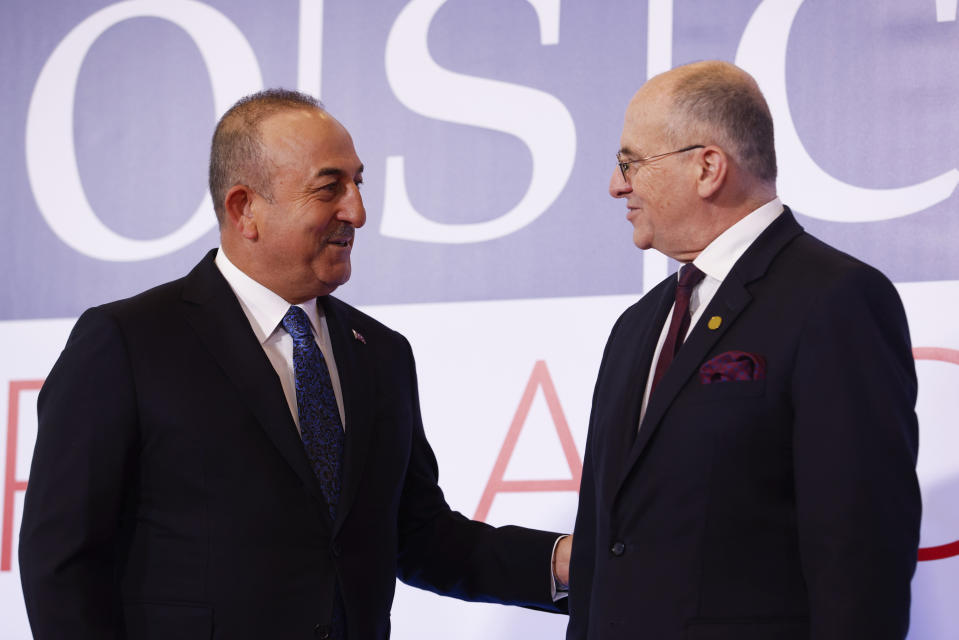 Polish Minister of Foreign Affairs Zbigniew Rau, right, welcomes his Turkish counterpart Mevlut Cavusoglu , left, during a high-level meeting of the Organization for Security and Cooperation in Europe in Lodz, Poland, Thursday, Dec. 1, 2022. The OSCE is Europe's largest security organization, one founded to maintain peace and stability on the continent. Russia's war against Ukraine is among the greatest challenges the body has faced in its nearly half century of existence. (AP Photo/Michal Dyjuk)